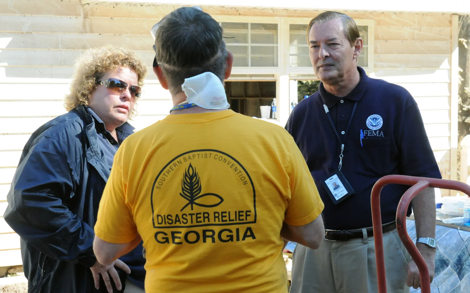 Community volunteers and workers speaking together at a FEMA event